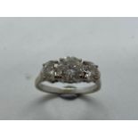 An impressive 18ct white gold three stone diamond ring, the centre stone approx 1.9ct, side stones