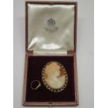 A 9ct yellow gold cameo, 6cm x 4.7cm, generally good, approx 17.2 grams, and an 18ct hallmarked gold