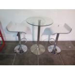 A glass top bar table, 91cm tall x 60cm diameter with two white laminated gas lift stools, some