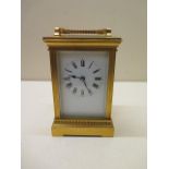 An early 20th century gilt brass carriage clock, 16cm high including handle, running, glass good