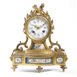 A late 19th century French ormolu and porcelain mantel clock, the eight day brass drum movement with