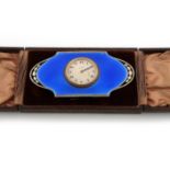 A silver-gilt and blue enamel travelling clock, by Walker and Hall, Birmingham 1927, shaped