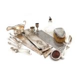 A mixed lot, comprising silver items: a sauce boat, a small photograph frame, two miniature