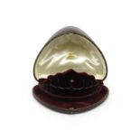 A fitted tiara case by Collingwood & Co., with red velvet interior and with hidden compartment,