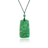 A carved jadeite jade pendant, suspended from a glass bead on green cord, pendant 5.7cm high