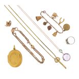 A mixed group of jewellery, including a Victorian gold locket pendant, a diamond three stone ring (