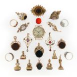 A mixed group of jewellery including eleven gold fob seals, a Victorian garnet-set gold brooch, a