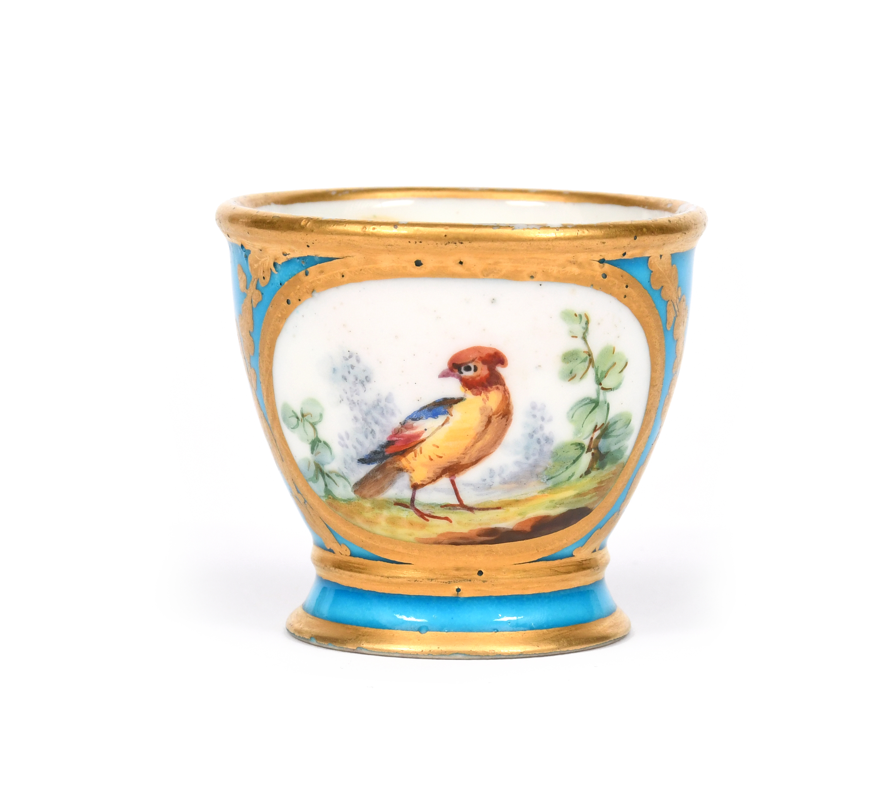 A Sèvres egg cup (coquetier) c.1771, painted with two panels of colourful birds perched on and