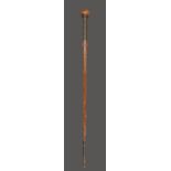 A Zulu staff South Africa with a spherical finial and a relief carved shaft with a lizard and a