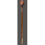 A Zulu dance staff South Africa with a disc finial and telephone wire zig-zag binding, 80.5cm long.