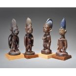 Four Yoruba Ibeji figures Nigeria including two male and two female, three with shells, beads, brass