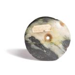 A Papua New Guinea nephrite disc Melanesia with a central hole with tapering sides, with the remains