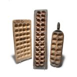 Three Africa mancala boards including Kenya with twenty-four recesses, 79cm long, Nigeria with a