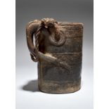 A Tibet milk pail with carved bands and a zoomorphic handle, with rope, 26.5cm high. Provenance