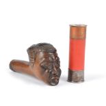 A Xhosa pipe bowl South Africa carved a head with an aluminium liner, 9cm long, and a cartridge