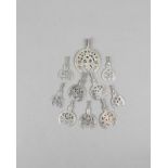 Ten Libyan hilal pendants silver coloured metal, including six with a star motif and four with