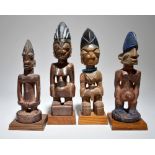 Four Yoruba Ibeji figures Nigeria including three males and one female, 26.5cm, 29cm, 30.5cm and