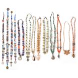 Thirteen South and Central America bead necklaces glass, stone, silver, shell, pottery with coins,