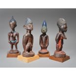 Four Yoruba Ibeji figures Nigeria including two male and two female, the females with beads and an