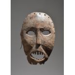 A Lega mask Democratic Republic of the Congo with an encrusted patina over pigments, 26.5cm high.