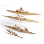 Three Inuit models of kayaks with figures Greenland wood, skin and bone, two of the figures with