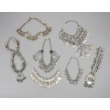 λSeven North African necklaces silver coloured metal, coral, glass beads, coins and medallions. (