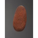 An Aboriginal churinga Australia carved linear decoration on both sides with a concentric circle