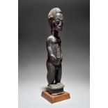 A Baule male figure Ivory Coast with a finely carved coiffure, facial and body scarifications and