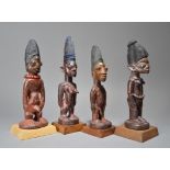 Four Yoruba Ibeji figures Nigeria including two males and two females, two with beads and two others