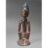 A Yoruba Ibeji male figure Nigeria 29.5cm high.