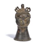 A Yoruba Ijebu hand bell omo Nigeria bronze, of human head form with a part diced coiffure with