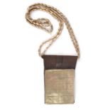 A Tuareg magic square necklace Niger leather with a silver coloured metal plaque with twenty incised