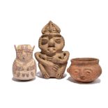 A Nazca effigy vessel Peru pottery, with polychrome decoration of a shaman holding plants, 14cm