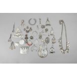 A collection of Nubian pendants silver coloured metal, including two Egyptian temple plaques, two