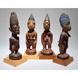 Four Yoruba Ibeji figures Nigeria including three female and one male, the male with filed teeth and