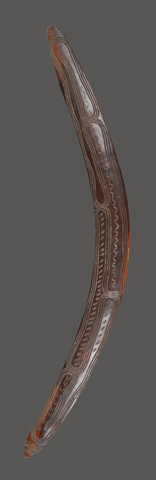 An Aboriginal boomerang Darling River, South East Australia with carved parallel linear and
