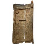 A Dogon door Bandiagara Escapement, Mali of two boards with carved linear decoration and a lock,