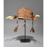 An Asmat headdress Papua New Guinea woven fibre with red and white pigment and with seeds and