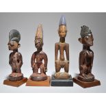 Four Yoruba Ibeji figures Nigeria including three males and a female, two with beads and one with