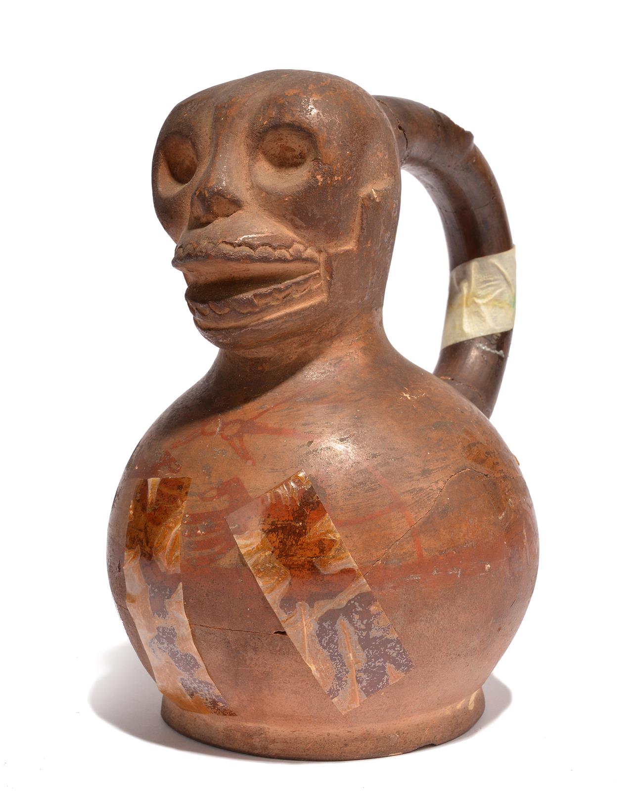 A Moche stirrup vessel Peru, circa 100 - 600 AD pottery with a skull top and with painted cloak