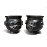 A pair of cephalomorphic cups earthenware with a face body and nodule back, 10.5cm high. (2)