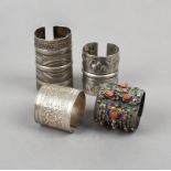 Four North African cuff bracelets silver coloured metal, including Siwa with bird and foliate