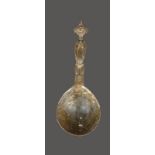 A Senufo ladle Ivory Coast cast brass with a female figure handle and with bands of linear and