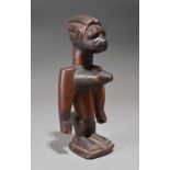 An Anago Ibeji female figure Benin with prominent breasts, 18.5cm high.