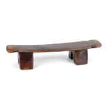 A Zulu neckrest South Africa with shaped ends and on four supports, 39.5cm long, 8.5cm high.