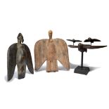 A Senufo bird sejan Ivory Coast with spread wings and with two smaller birds attached, with
