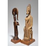 A Mossi doll Burkina Faso with incised decoration, 33cm high, and a seated female figure, probably