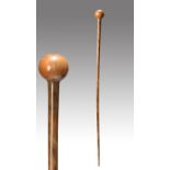 λA Zulu knobkerrie South Africa black rhinoceros horn with a spherical head and a tapering shaft,