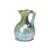 A Roman glass oinochoe circa 3rd century AD with a trefoil spout having a folded rim and with an