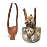 A Yoruba Gelede mask Nigeria with a leopard and antelope surmount, with pigment decoration, 47cm